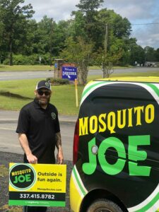 Mosquito Joe of Lake Charles Technician with Mosquito Joe sign and van in Louisiana.
